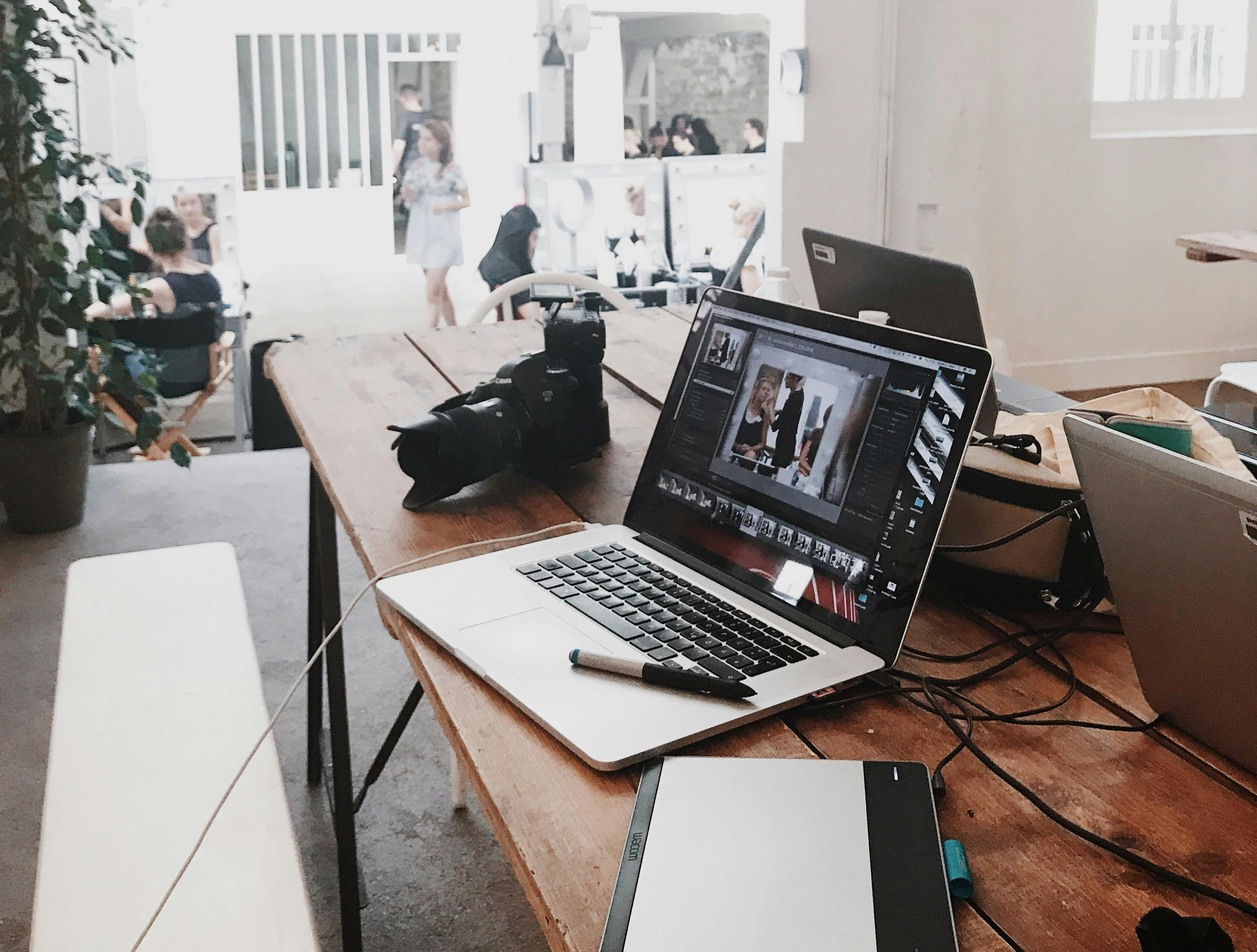 laptops in office with workers in background